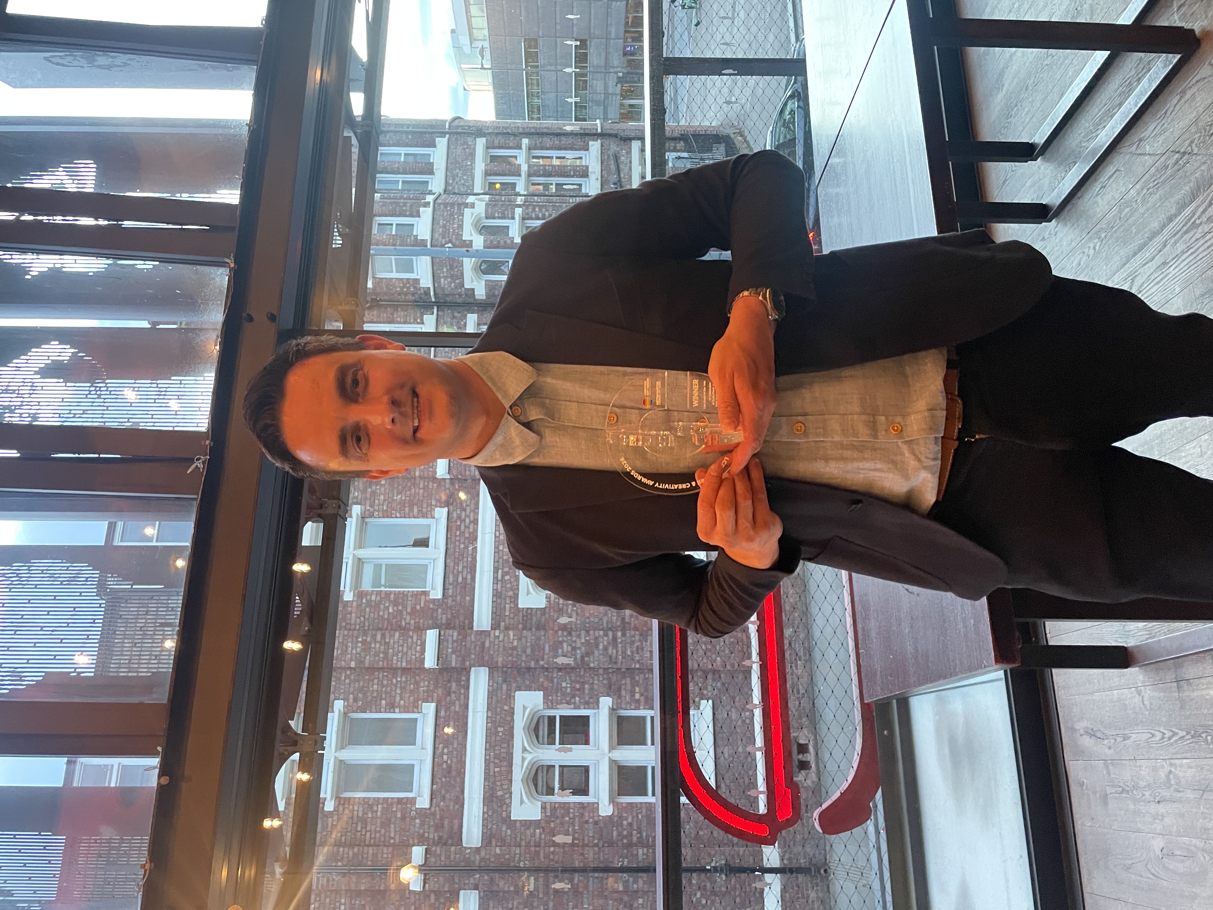 Daniel Nicolson holding an award at an event